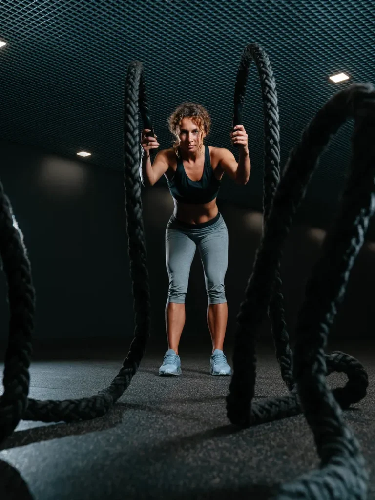 young-fit-woman-is-engaged-functional-training-gym-performing-crossfit-exercises-with-combat-ro